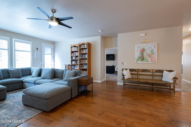 living room featuring hardwood / wood-style flooring and ceiling fan