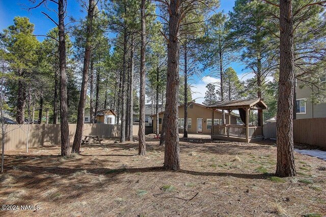 view of yard with a gazebo and a wooden deck