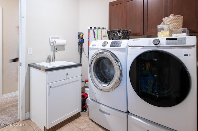 laundry room featuring sink, cabinets, separate washer and dryer, and light tile patterned flooring