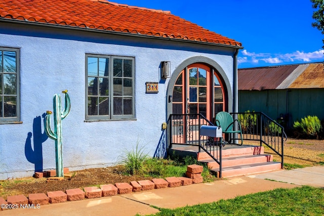 311 N Winslow Ave, Winslow, AZ 86047 - property entrance with a tiled roof and stucco siding