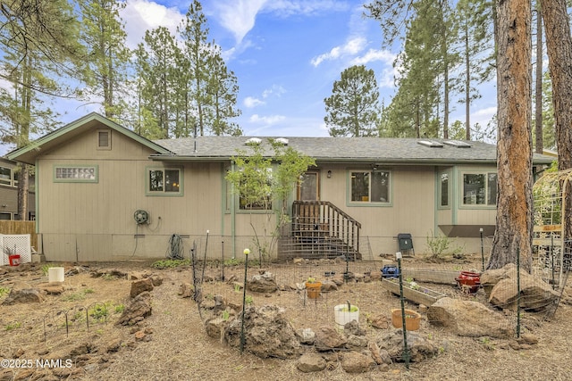 ranch-style home with a shingled roof