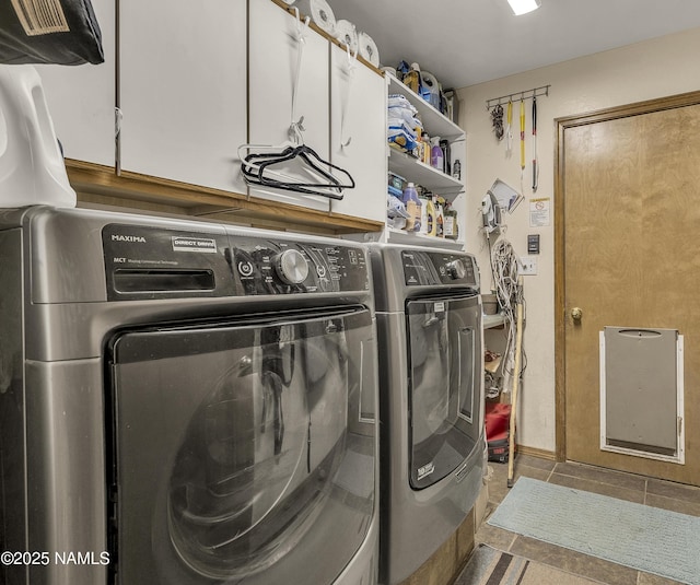washroom featuring cabinet space, tile patterned floors, and washer and dryer