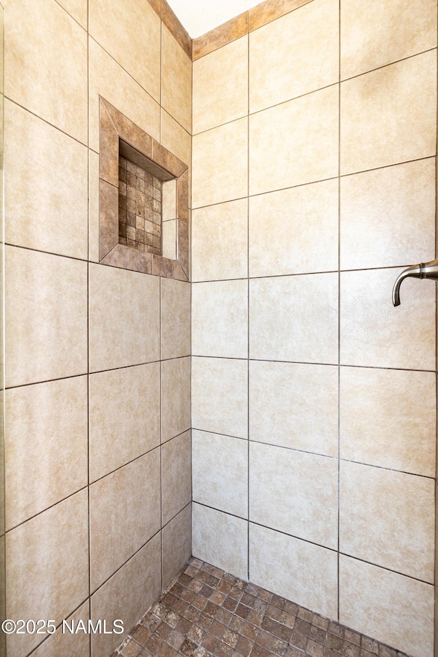 full bath with a tile shower