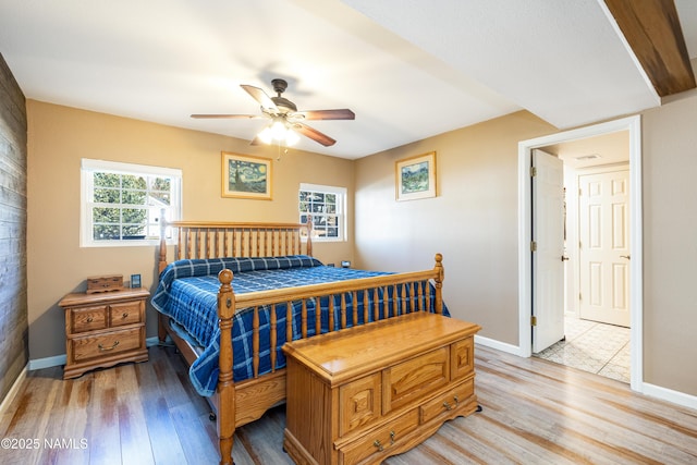 bedroom with light wood-style flooring and baseboards