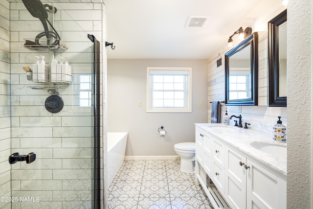 full bathroom with toilet, a wealth of natural light, baseboards, and a sink