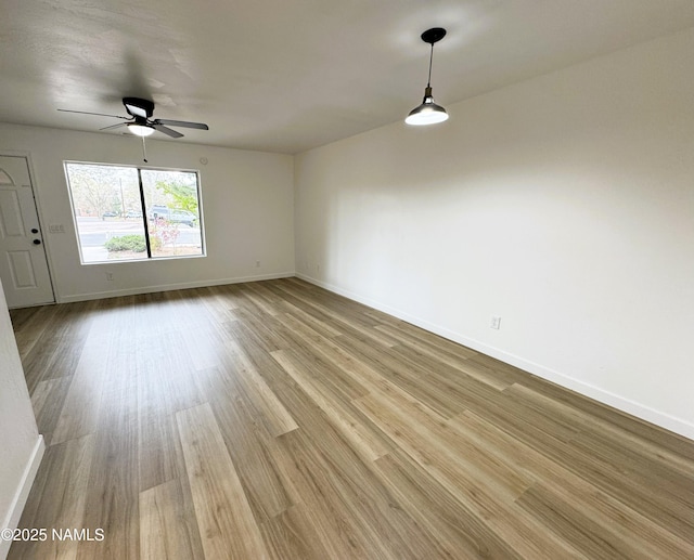 1807 N Main St, Flagstaff, AZ 86004 - unfurnished room with light wood-style floors, baseboards, and ceiling fan