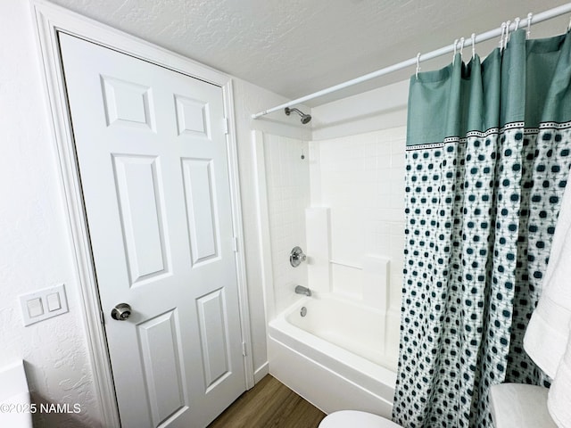 1807 N Main St, Flagstaff, AZ 86004 - bathroom with a textured ceiling, shower / bathtub combination with curtain, and wood finished floors