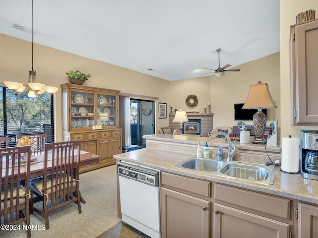 kitchen with sink, hanging light fixtures, white dishwasher, and a healthy amount of sunlight