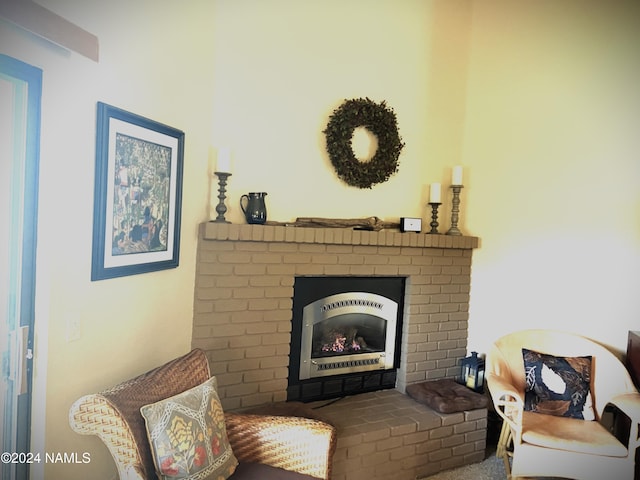 sitting room with a brick fireplace