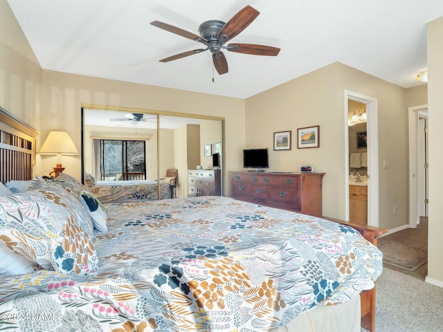 carpeted bedroom featuring a closet, ceiling fan, and ensuite bathroom