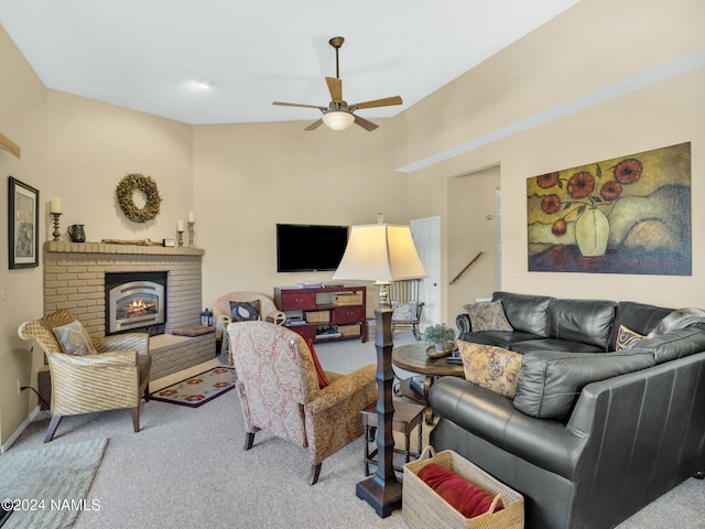 living room with ceiling fan, light colored carpet, and a brick fireplace