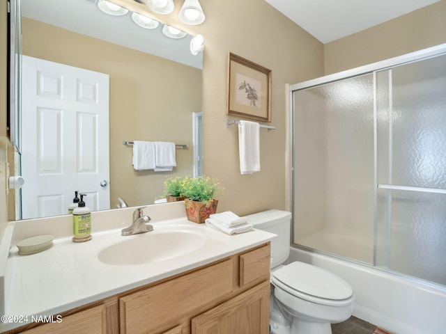 full bathroom featuring vanity, toilet, and enclosed tub / shower combo