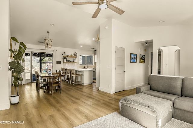 9654 Heritage Dr, Flagstaff, AZ 86004 - living room featuring ceiling fan, arched walkways, light wood-type flooring, high vaulted ceiling, and recessed lighting