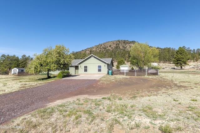9654 Heritage Dr, Flagstaff, AZ 86004 - view of front of property with a mountain view and dirt driveway