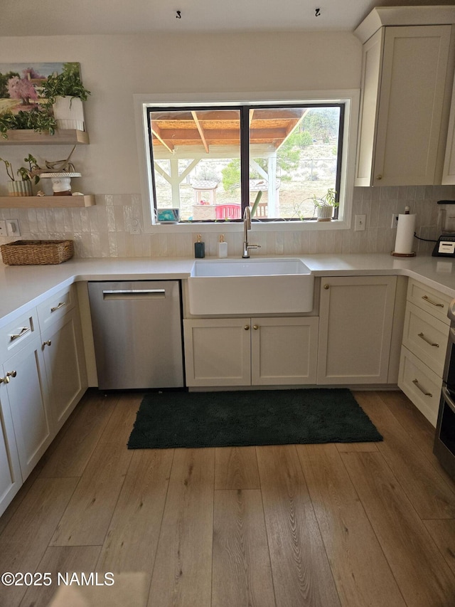 9654 Heritage Dr, Flagstaff, AZ 86004 - kitchen featuring stainless steel dishwasher, a sink, wood-type flooring, and open shelves