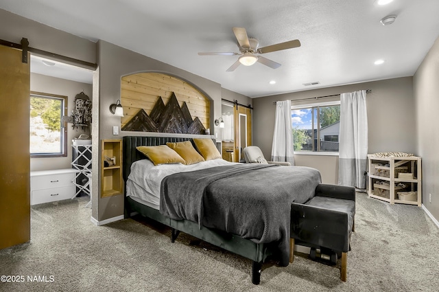 9654 Heritage Dr, Flagstaff, AZ 86004 - bedroom featuring a barn door, carpet flooring, baseboards, recessed lighting, and a ceiling fan