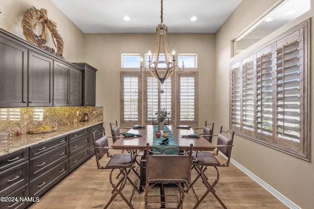 dining space featuring an inviting chandelier and light hardwood / wood-style flooring