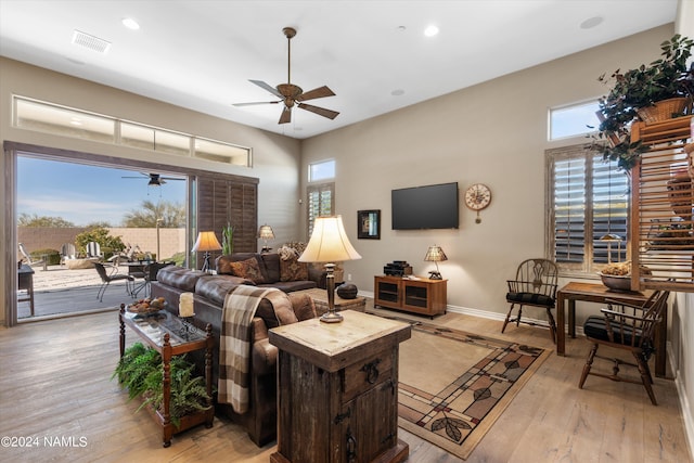 living room with light wood-type flooring and ceiling fan