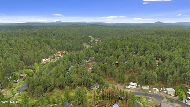 3135 Ancient Trl, Flagstaff, AZ 86005 - aerial view of property and surrounding area featuring a heavily wooded area and a mountain backdrop