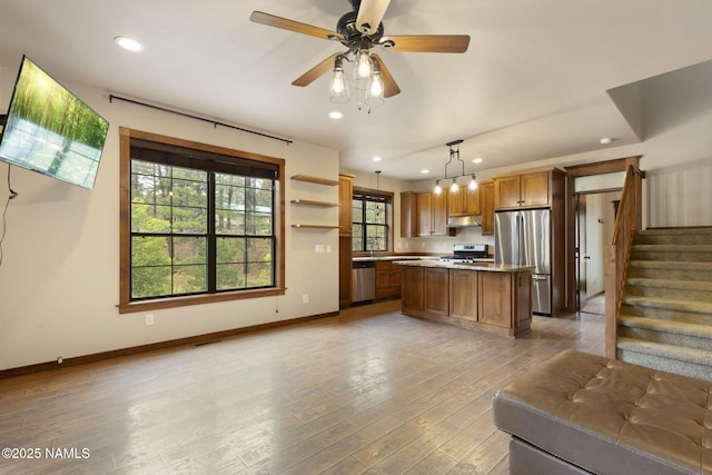 3135 Ancient Trl, Flagstaff, AZ 86005 - kitchen featuring stainless steel appliances, under cabinet range hood, recessed lighting, baseboards, and open floor plan