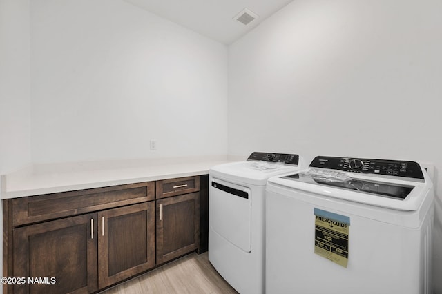 555 N Valerian Ln Lot 24, Flagstaff, AZ 86004 - washroom with washer and clothes dryer, light wood-type flooring, and cabinet space