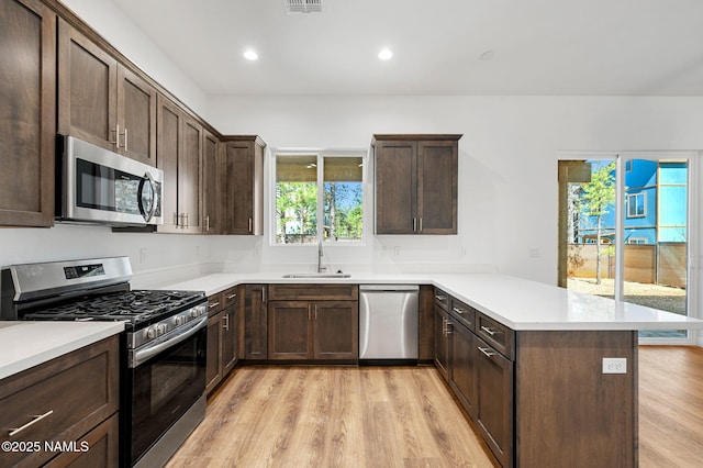 555 N Valerian Ln Lot 24, Flagstaff, AZ 86004 - kitchen with appliances with stainless steel finishes, a sink, a peninsula, light wood-style flooring, and recessed lighting