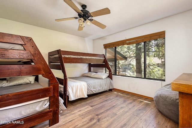 bedroom with ceiling fan and hardwood / wood-style flooring