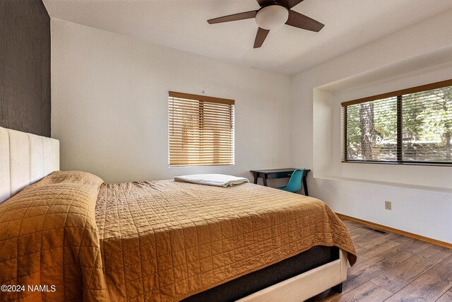 bedroom with ceiling fan and wood-type flooring