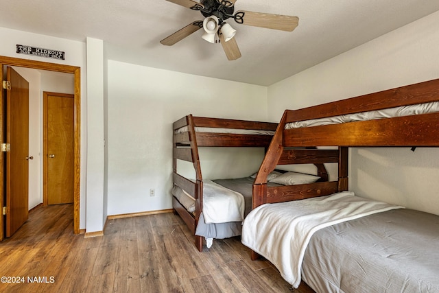 unfurnished bedroom with ceiling fan and dark hardwood / wood-style floors