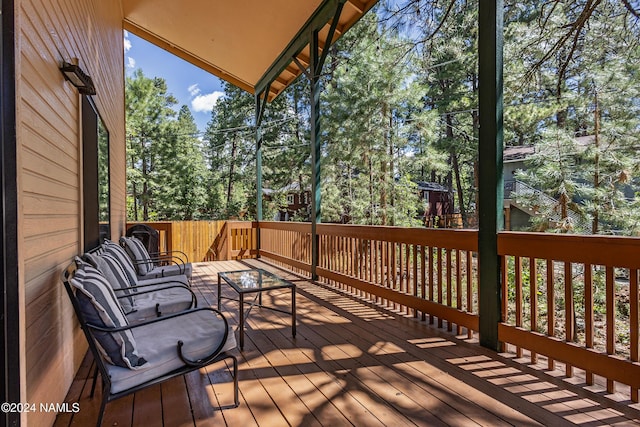 wooden terrace with an outdoor hangout area