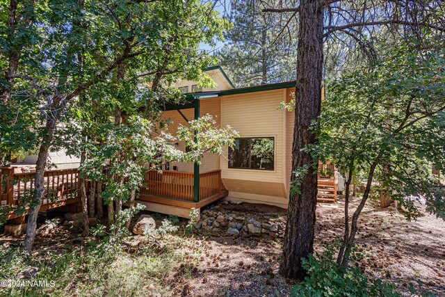 view of side of property featuring a deck