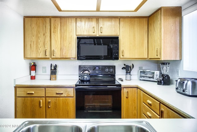 kitchen featuring black appliances and a healthy amount of sunlight