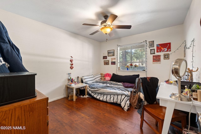 bedroom with a ceiling fan and wood finished floors