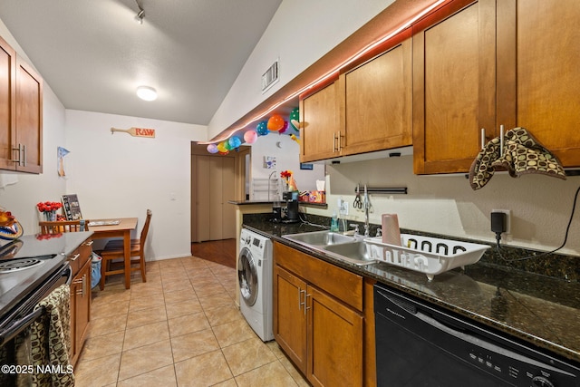 kitchen featuring visible vents, washer / dryer, brown cabinetry, and black appliances