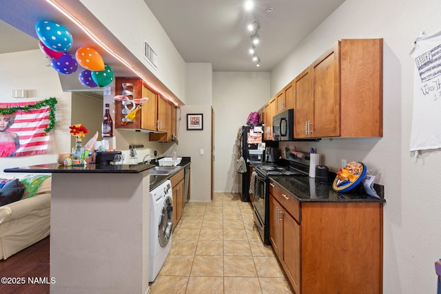 kitchen with washer / clothes dryer, brown cabinets, a sink, black appliances, and a peninsula