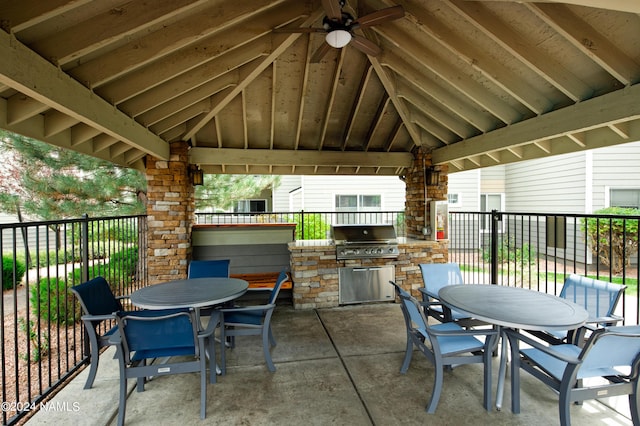 view of patio / terrace with an outdoor kitchen, area for grilling, fence, a gazebo, and outdoor dining space