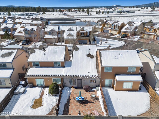 snowy aerial view featuring a residential view