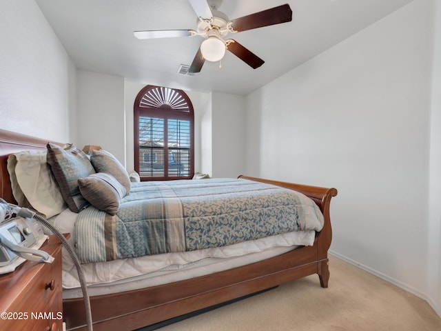 carpeted bedroom with baseboards and a ceiling fan