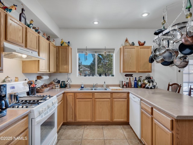 kitchen featuring white appliances, light tile patterned floors, a peninsula, a sink, and under cabinet range hood