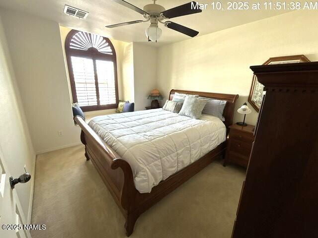 9123 W Arden Ln, Bellemont, AZ 86015 - carpeted bedroom featuring baseboards, a ceiling fan, and visible vents