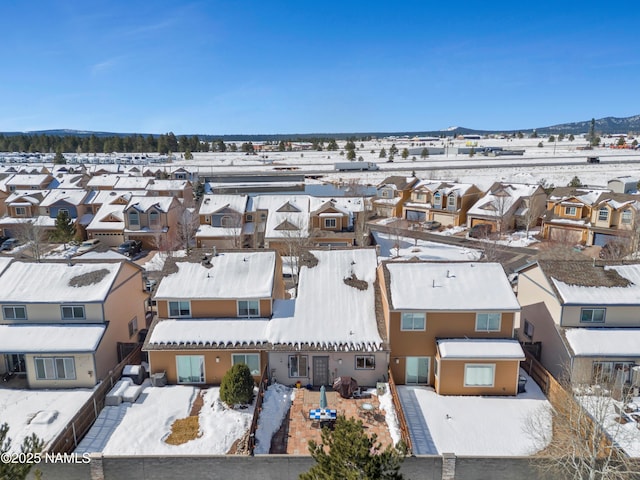 snowy aerial view featuring a residential view