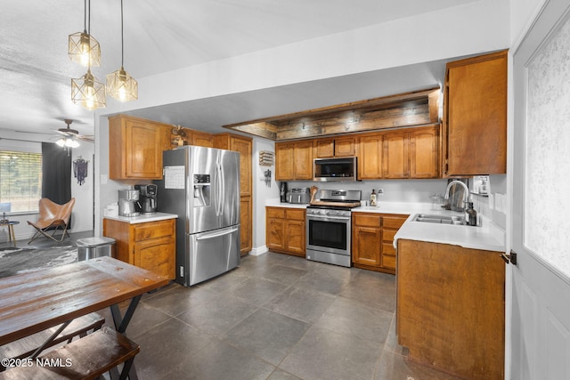 kitchen with ceiling fan, sink, hanging light fixtures, and stainless steel appliances