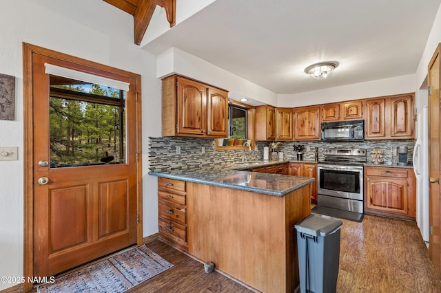 kitchen with electric stove, black microwave, a peninsula, brown cabinets, and a sink