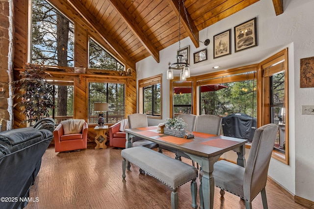 sunroom / solarium with a chandelier