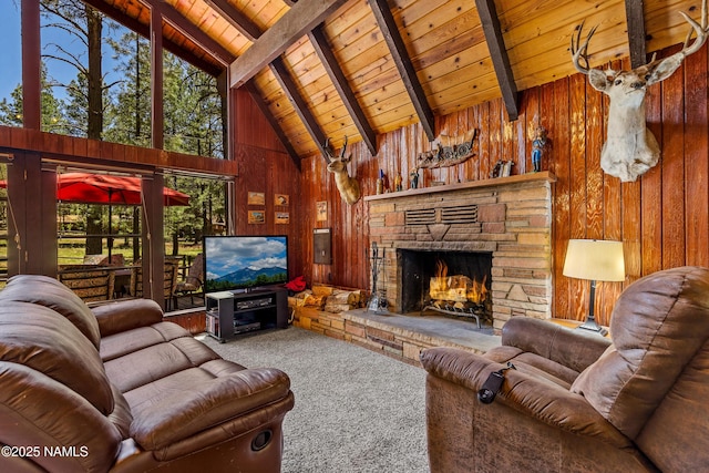 325 Lodge Dr, Munds Park, AZ 86017 - carpeted living room with wooden ceiling with exposed beams, wooden walls, high vaulted ceiling, and a fireplace