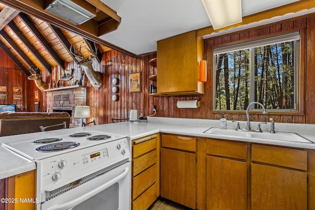 325 Lodge Dr, Munds Park, AZ 86017 - kitchen featuring white range with electric stovetop, wooden walls, a sink, open shelves, and light countertops