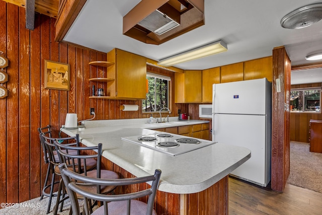 325 Lodge Dr, Munds Park, AZ 86017 - kitchen with white appliances, a sink, wood walls, light countertops, and a peninsula