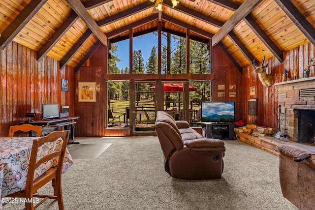 325 Lodge Dr, Munds Park, AZ 86017 - carpeted living room with high vaulted ceiling, wooden walls, wood ceiling with exposed beams, and a stone fireplace