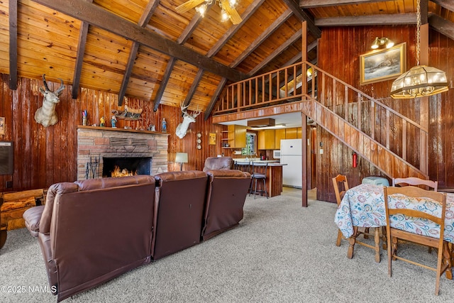 325 Lodge Dr, Munds Park, AZ 86017 - living area with wooden ceiling, light carpet, wooden walls, ceiling fan, and a fireplace
