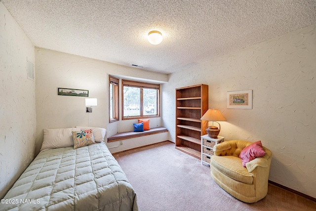 bedroom with carpet flooring and a textured ceiling